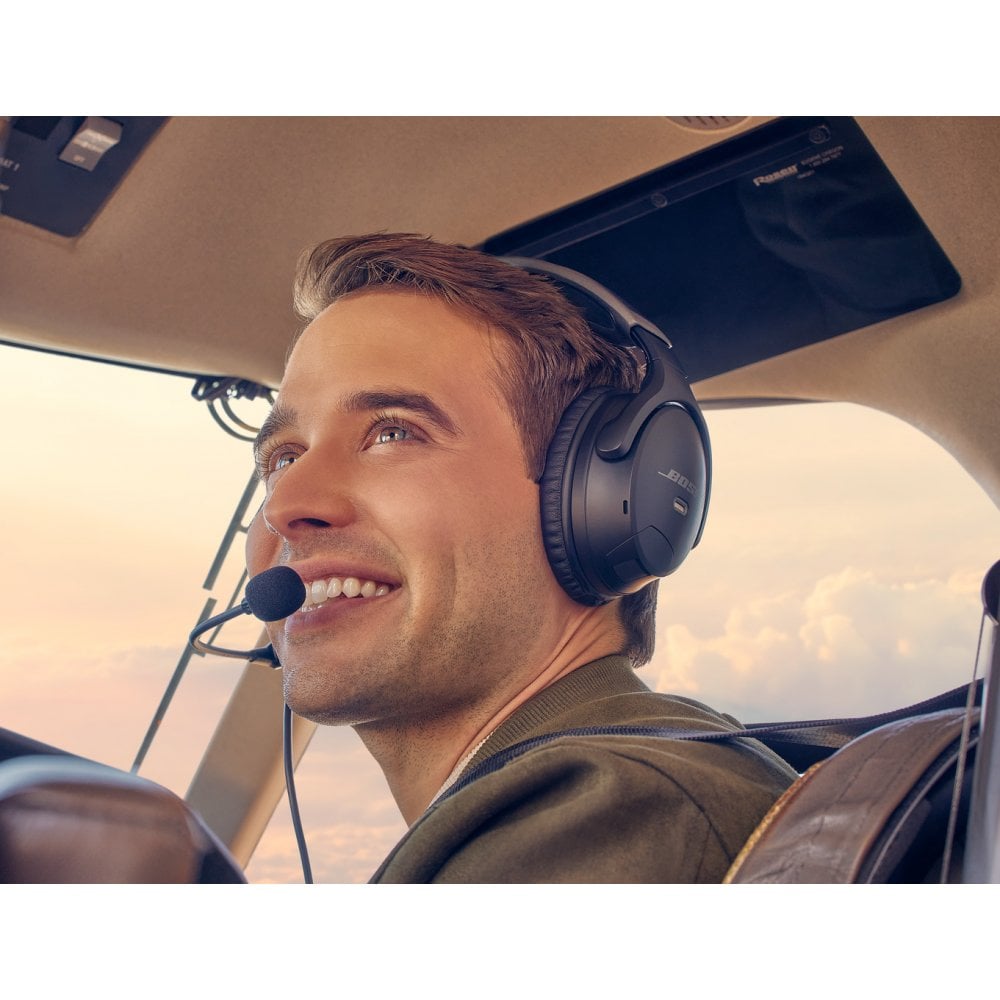 pilot smiling in cockpit wearing Bose A30 pilot headset